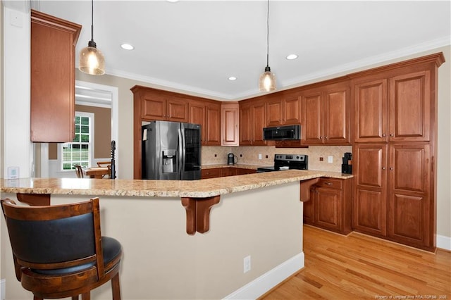 kitchen featuring stainless steel fridge with ice dispenser, range with electric cooktop, black microwave, decorative backsplash, and a peninsula