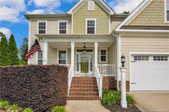 view of front of property with covered porch, driveway, and an attached garage