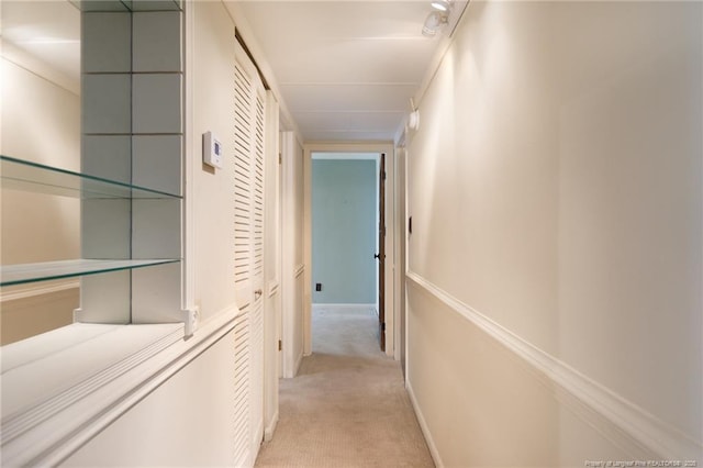 hallway featuring light colored carpet