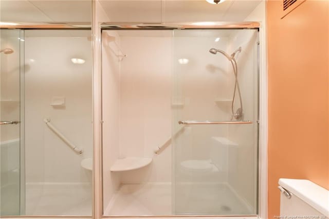 bathroom with toilet and a shower stall