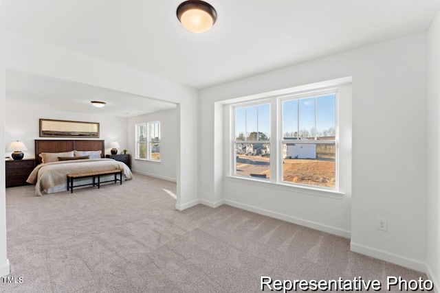 carpeted bedroom featuring baseboards