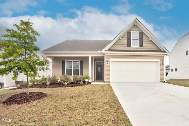 view of front of property with a garage, a front yard, concrete driveway, and covered porch