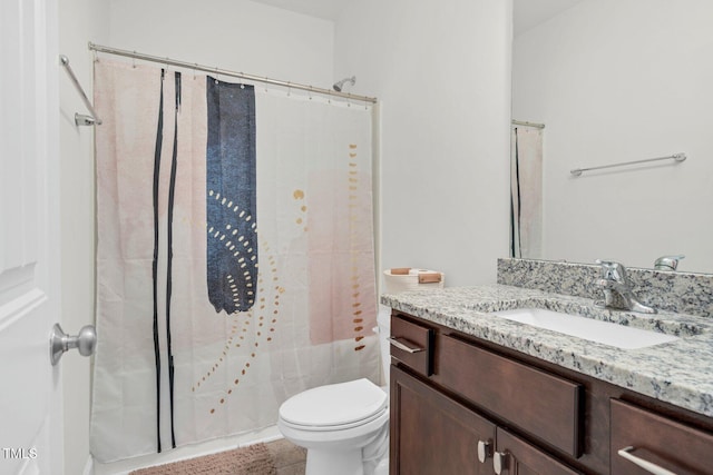 bathroom with vanity, a shower with shower curtain, and toilet