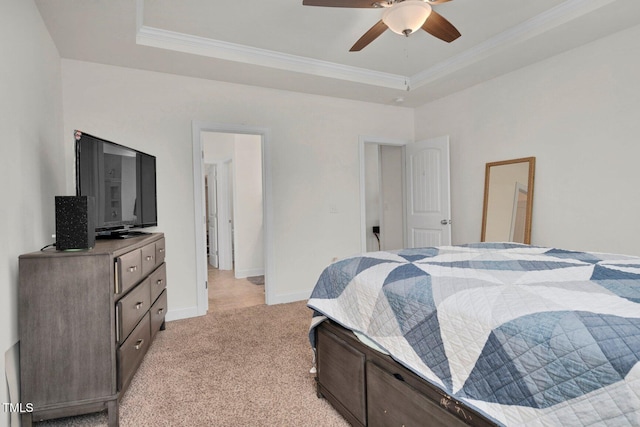 bedroom with ornamental molding, a tray ceiling, light carpet, baseboards, and a ceiling fan