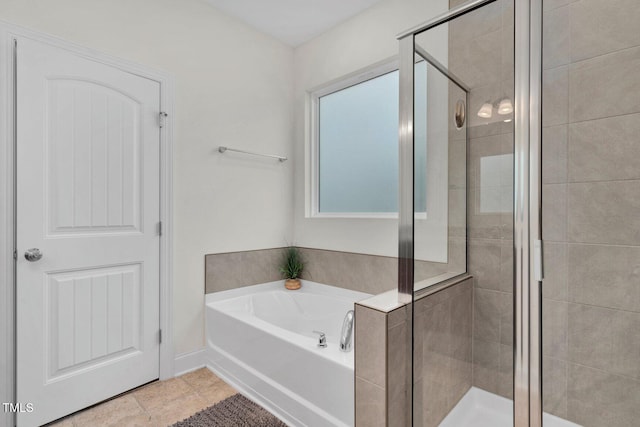 full bath featuring a stall shower and a garden tub