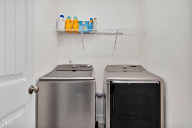 clothes washing area with washing machine and clothes dryer