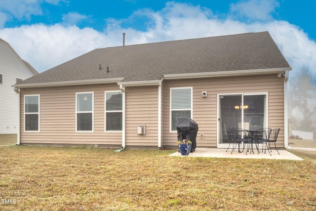 rear view of house featuring a patio area and a lawn