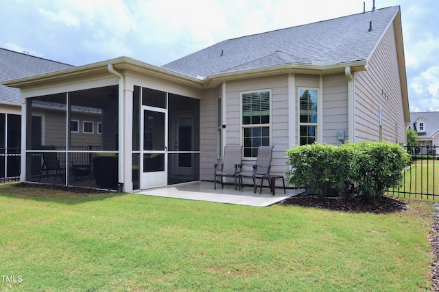 back of property with a sunroom, a patio, and roof with shingles