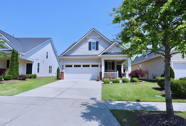 view of front of property with a porch, driveway, a front yard, and brick siding