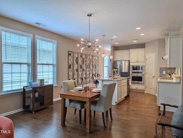 1033 Cuthbert Ln, Durham, NC 27703 - dining area with a chandelier, dark wood-style floors, baseboards, and recessed lighting