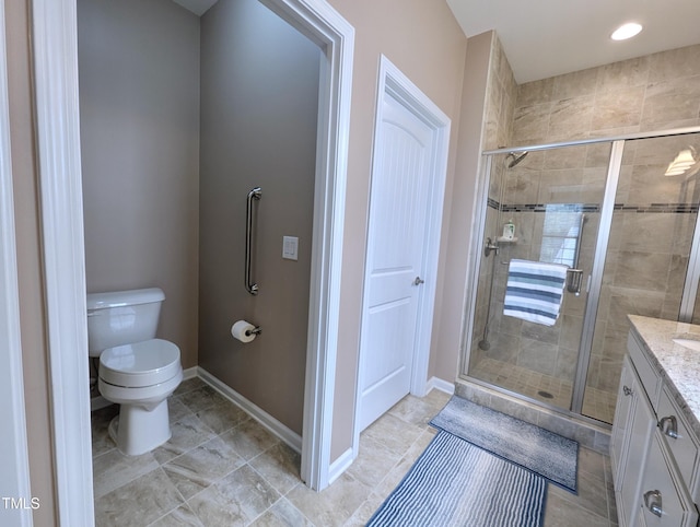 1033 Cuthbert Ln, Durham, NC 27703 - full bathroom featuring a stall shower, vanity, toilet, baseboards, and tile patterned flooring