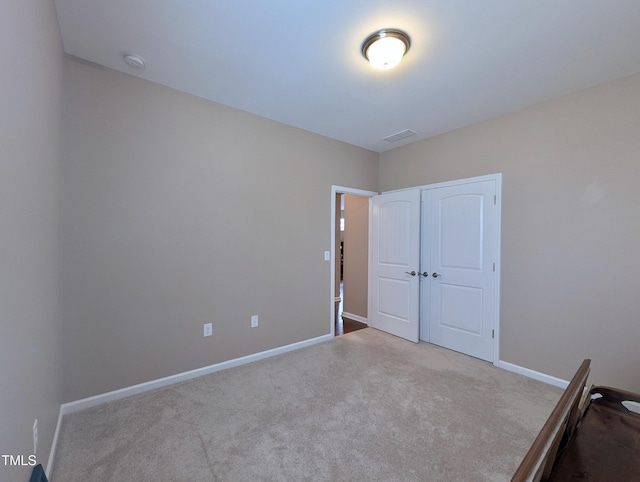 1033 Cuthbert Ln, Durham, NC 27703 - unfurnished bedroom with carpet floors, baseboards, and a closet