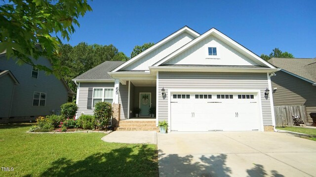 65 Wood Green Dr, Wendell, NC 27591 - view of front of property with a front lawn, board and batten siding, an attached garage, and concrete driveway