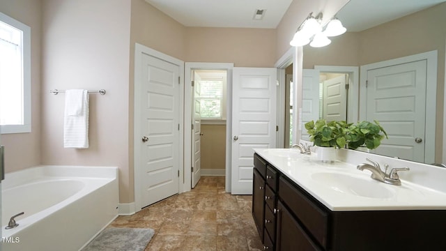 65 Wood Green Dr, Wendell, NC 27591 - bathroom featuring a bath, a healthy amount of sunlight, and a sink