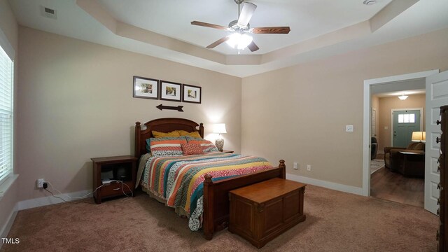 65 Wood Green Dr, Wendell, NC 27591 - bedroom featuring a tray ceiling, baseboards, ceiling fan, visible vents, and light carpet