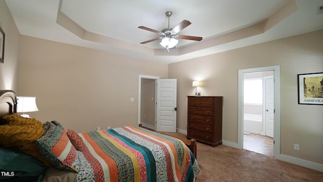 65 Wood Green Dr, Wendell, NC 27591 - carpeted bedroom with a ceiling fan, ensuite bathroom, baseboards, and a raised ceiling