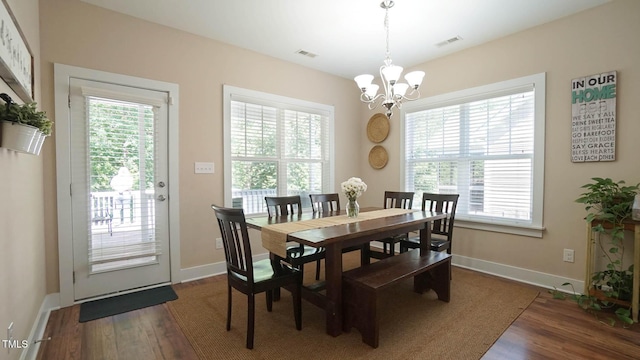 65 Wood Green Dr, Wendell, NC 27591 - dining area with a chandelier, baseboards, visible vents, and dark wood finished floors