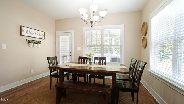 65 Wood Green Dr, Wendell, NC 27591 - dining space featuring baseboards, dark wood finished floors, and a chandelier