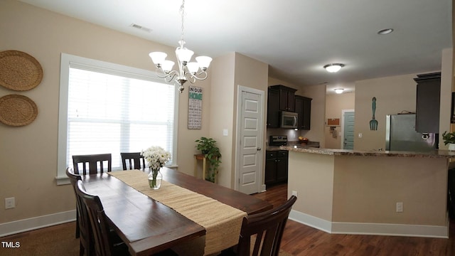 65 Wood Green Dr, Wendell, NC 27591 - dining area with a chandelier, baseboards, visible vents, and dark wood finished floors