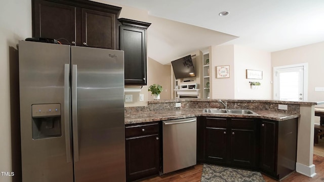 65 Wood Green Dr, Wendell, NC 27591 - kitchen with a sink, a peninsula, dark stone countertops, wood finished floors, and appliances with stainless steel finishes