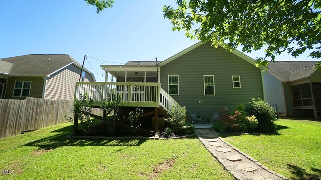 65 Wood Green Dr, Wendell, NC 27591 - rear view of property featuring a yard, stairway, fence, and a wooden deck