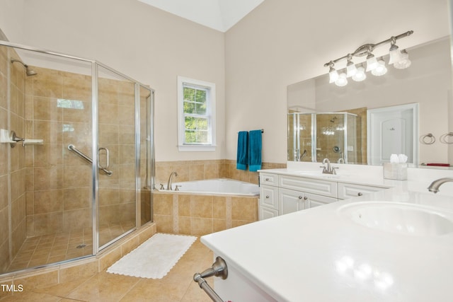 full bathroom featuring a bath, a sink, a shower stall, tile patterned flooring, and double vanity