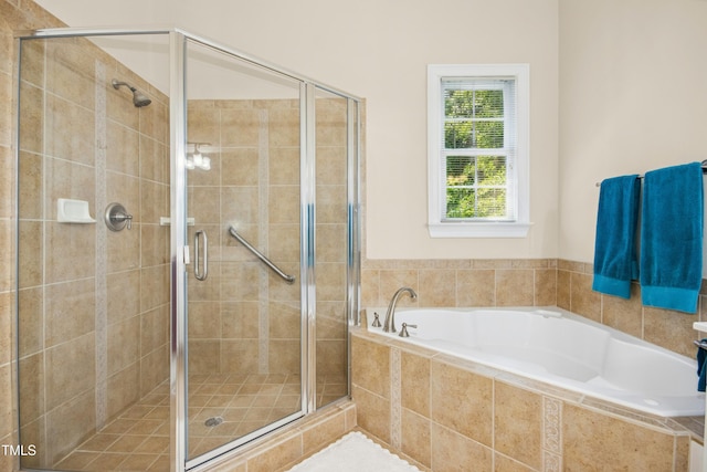 bathroom with a shower stall and a garden tub