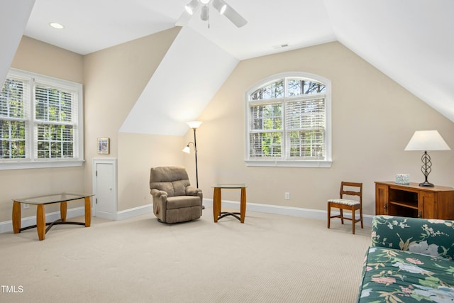 sitting room featuring carpet, a ceiling fan, visible vents, baseboards, and vaulted ceiling