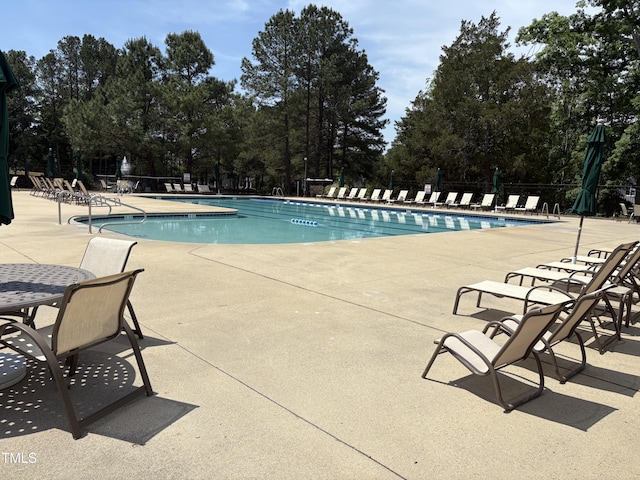 pool featuring a patio area and fence