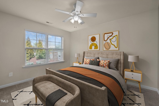 carpeted bedroom featuring baseboards and a ceiling fan