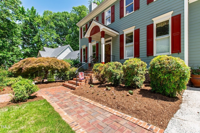view of front of home featuring a chimney