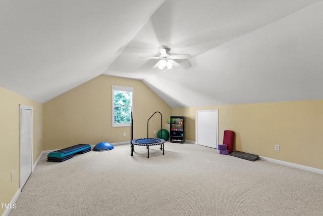 recreation room featuring carpet floors, a ceiling fan, vaulted ceiling, and baseboards