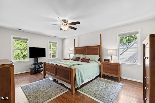 bedroom featuring wood finished floors, ceiling fan, and baseboards