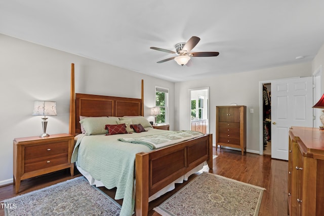 bedroom featuring dark wood-style floors, ceiling fan, and baseboards