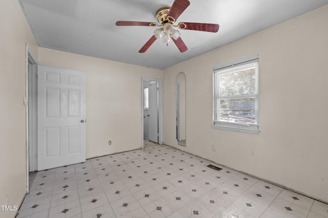 unfurnished room with ceiling fan and light flooring