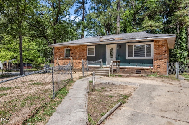 view of front of home with a gate and brick siding