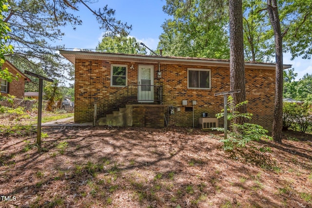 view of front of property with brick siding and fence