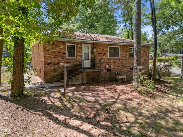 back of house with brick siding