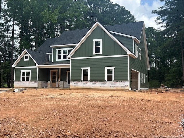 194 Landon Rdg, Sanford, NC 27330 - view of front of home featuring board and batten siding, covered porch, an attached garage, and a shingled roof