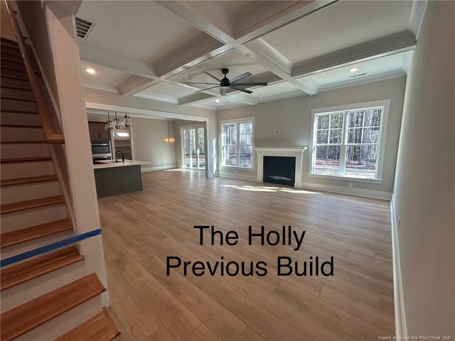 194 Landon Rdg, Sanford, NC 27330 - unfurnished living room featuring a fireplace, ceiling fan, stairway, light wood-type flooring, and beamed ceiling