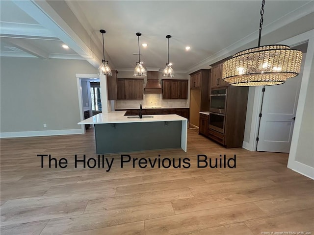 194 Landon Rdg, Sanford, NC 27330 - kitchen featuring stainless steel double oven, premium range hood, a breakfast bar, light wood-style flooring, and crown molding