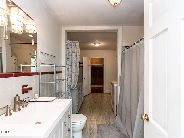 full bathroom with vanity, tile walls, toilet, and wood finished floors