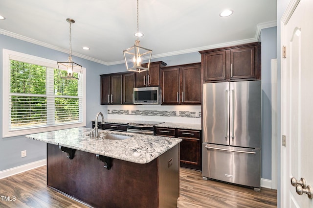 91 Carsons Creek Trl, Wendell, NC 27591 - kitchen with stainless steel appliances, a sink, dark brown cabinetry, an island with sink, and ornamental molding