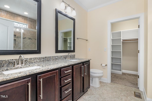 91 Carsons Creek Trl, Wendell, NC 27591 - bathroom featuring ornamental molding, a walk in closet, double vanity, baseboards, and toilet