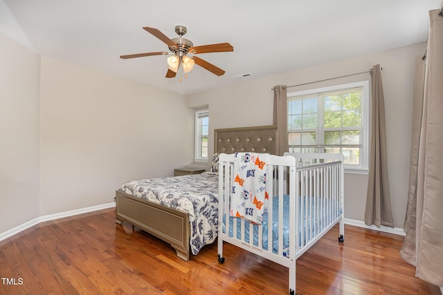 776 Averasboro Dr, Clayton, NC 27520 - bedroom with baseboards, multiple windows, visible vents, and wood finished floors