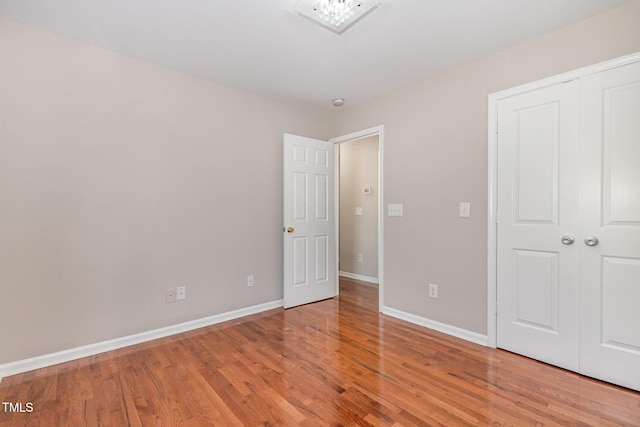 776 Averasboro Dr, Clayton, NC 27520 - unfurnished bedroom with a closet, wood finished floors, and baseboards
