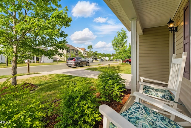 4108 Lady Slipper Ln, Durham, NC 27704 - view of grassy yard featuring covered porch and a residential view