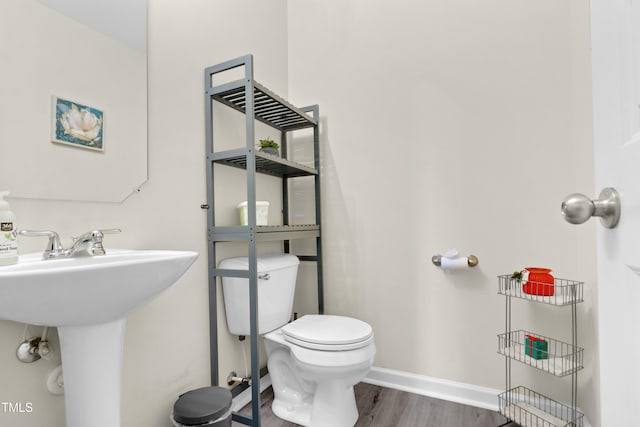 4108 Lady Slipper Ln, Durham, NC 27704 - half bath featuring wood finished floors, toilet, baseboards, and a sink