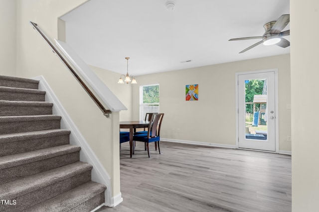 4108 Lady Slipper Ln, Durham, NC 27704 - stairs featuring wood finished floors, a chandelier, baseboards, and a ceiling fan