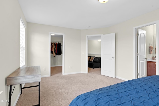 4108 Lady Slipper Ln, Durham, NC 27704 - carpeted bedroom featuring a spacious closet, baseboards, connected bathroom, and a closet